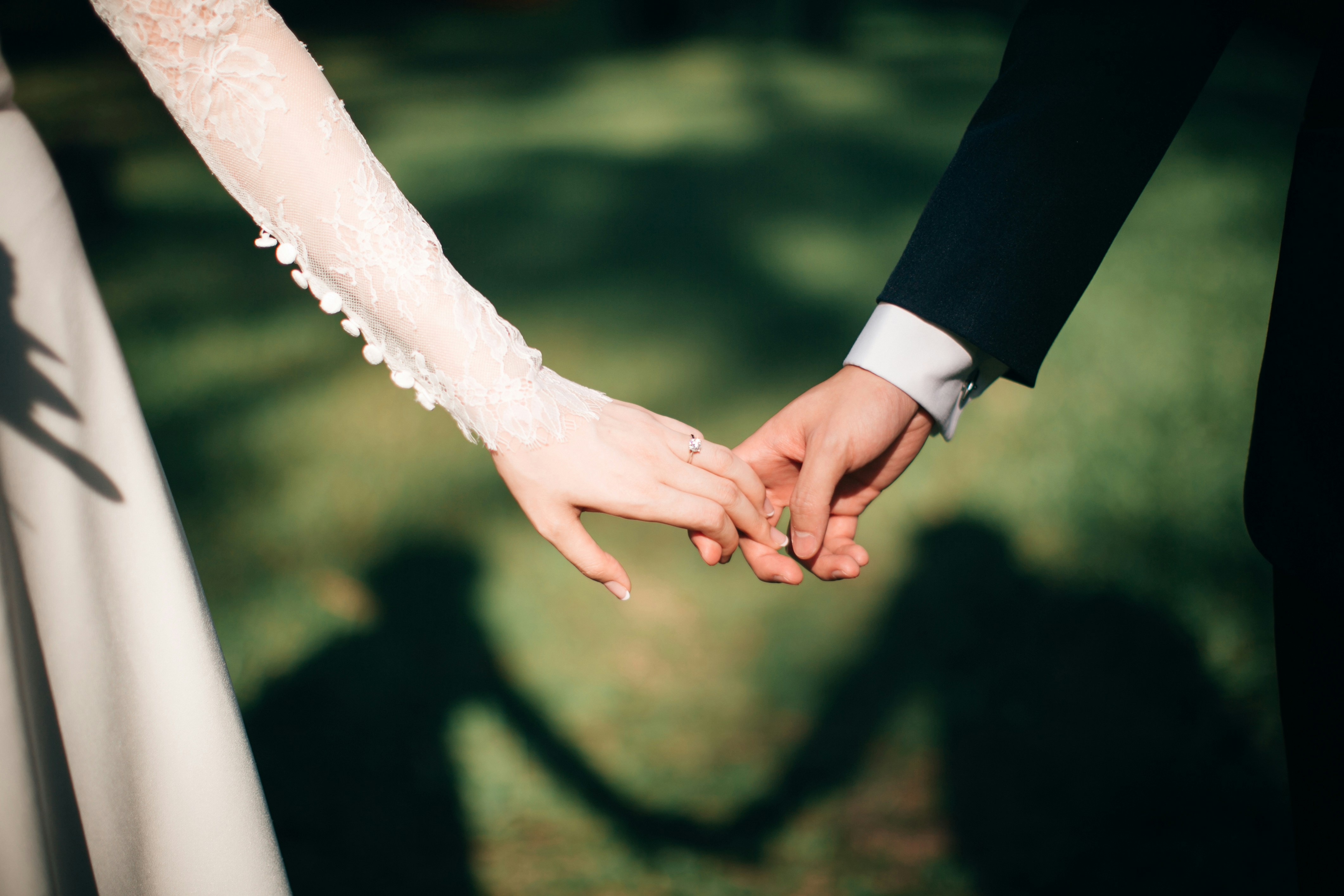 Immagine di sposa e sposo che si tengono la mano
