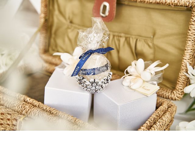 Candle holder daisies with cream colored candle and sugared almonds